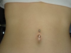 Piercing belly button of a 14 year's old girl